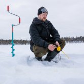 Ice fishing with snowmobile from Hotel Wilderness Inari